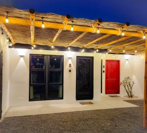 two black and red doors on a building with lights at Departamento con Look off in La Paz