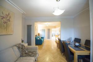 a living room with a couch and a dining room at Chester Apartments in Chester