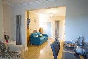a living room with a blue couch and a table at Chester Apartments in Chester