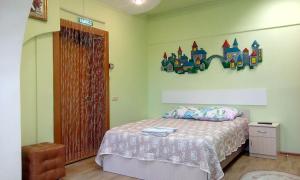 ウラジオストクにあるフィリン イ サヴァ ミニ ホテルのベッドルーム1室(城の壁にステッカー付きのベッド1台付)