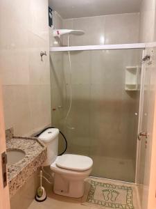 a bathroom with a toilet and a glass shower at Apto de 3 Quartos Vista lateral do Mar a 2km da praia do Araçagy in São Luís