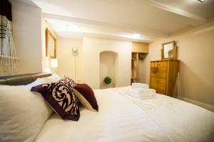 a bedroom with a large white bed with towels on it at Chester Apartments in Chester