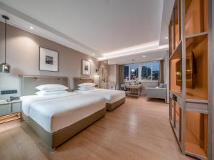 Postel nebo postele na pokoji v ubytování Chongqing Liangjiang New District Yunxi Hotel
