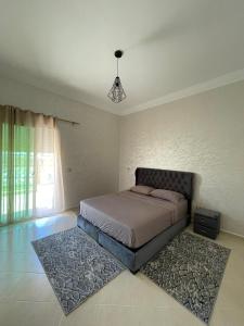 a bedroom with a bed and a rug at Al Kawtar in Mansouria