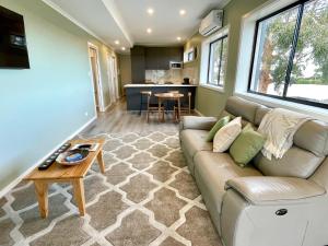 a living room with a couch and a table at Apartments on Centenary in Kingscote