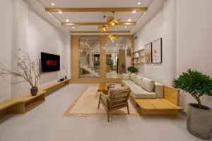 a living room with a couch and a table at Serenity Villa - Near My Khe Beach & City Center by The Key in Da Nang
