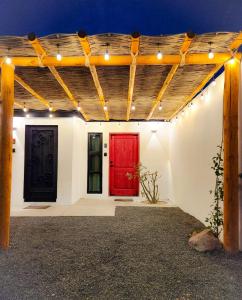 a red door on a white wall with lights at Habitación tipo Look Off in La Paz