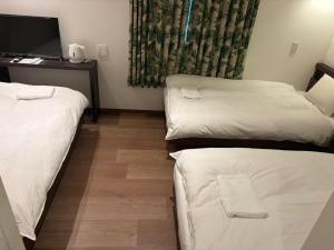 Postel nebo postele na pokoji v ubytování MARUKOU HOTEL