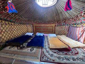 a room with two beds in a yurt at Aalam yurt camp Altyn-Arashan in Mineralʼnyy Istochnik Altyn-Arasan +102 photos