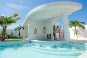 a villa with a swimming pool with palm trees at Prava in Yonaha