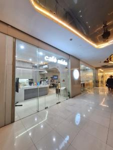 a lobby with a store with a large glass window at Sky Lux Suite by Elnora at Victoria Sports Tower Kamuning Edsa Southbound in Manila +82 photos