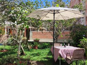 a table with an umbrella in a garden at Hostal Normandie in Pamplona