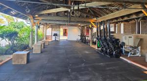 a gym with lots of exercise equipment in a building at Le Colibri in Saint-François