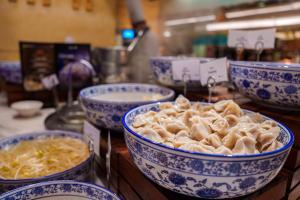 a bunch of bowls of food sitting on a table at Radisson Blu Hotel Shanghai New World in Shanghai