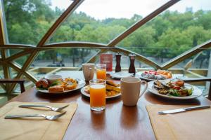 a table with plates of food and glasses of orange juice at Radisson Blu Hotel Shanghai New World in Shanghai