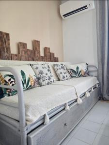 a couch with pillows on it in a room at Le Colibri in Saint-François +18 photos