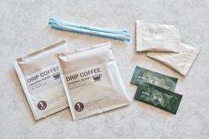 a group of three packets of dark coffee and two chopsticks at Hotel Villa Fontaine Tokyo-Hamamatsucho in Tokyo