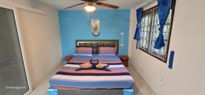 a bedroom with two beds and a blue wall at Sabai Resort in Ao Nang Beach +157 photos