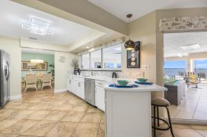 a kitchen and living room with a view of the ocean at SeaBreeze Vista in Cape Coral