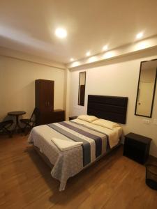 a bedroom with a large bed and a table at Hotel Sol de Marcona in San Juan +8 photos