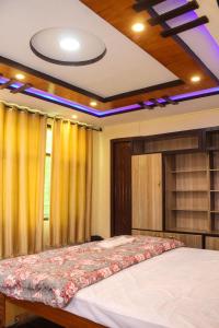 a bedroom with a large bed with yellow curtains at Melody Hill Skardu in Skardu