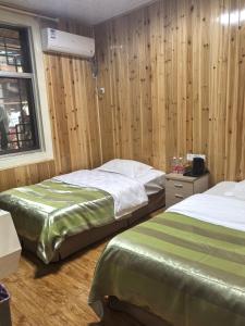 Postel nebo postele na pokoji v ubytování PI Network Inn
