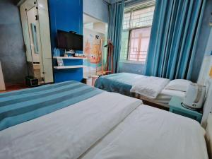 Postel nebo postele na pokoji v ubytování PI Network Inn
