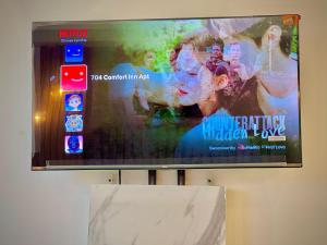 a flat screen tv hanging on a wall at Executives studio apartment-Centaurus viewing apartments in Dargai