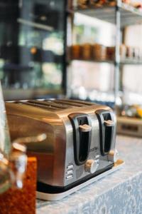 a toaster sitting on top of a counter at Phoem Phoon 2 Hotel in Nan
