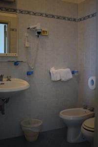 a bathroom with a sink and a toilet at Hotel Astoria in Pesaro +64 photos