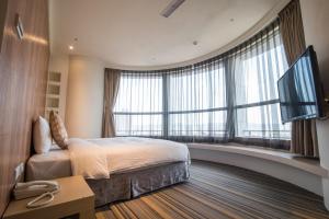Rúm í herbergi á Merryday Hotel Banqiao