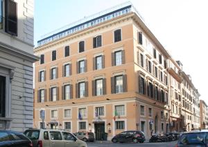 Un gran edificio con coches aparcados delante. en Best Western Hotel Artdeco, en Roma
