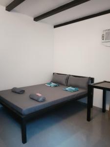 a bed with two pillows on it in a room at Shawe pension house in San Remigio +9 photos