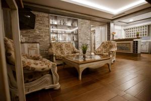 a living room with two chairs and a coffee table at Wine Hotel Cesarica in Međugorje