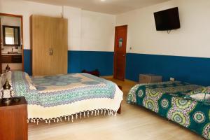 Letto o letti in una camera di Hotel Portobelo Guatape