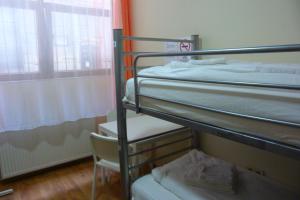 A bed or beds in a room at Center Hostel and Guest House