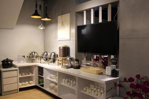 a room with a shelf with a flat screen tv at Hiinn B&B in Hualien City