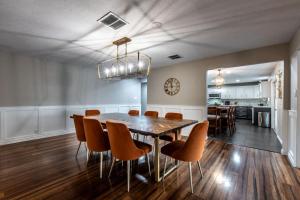 a dining room with a table and chairs at Classic Coastal Getaway Sleeps 34 - 2 Homes 2 Pools in Corpus Christi