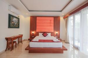 Postel nebo postele na pokoji v ubytování Adipana Bungalow-Balinese Room