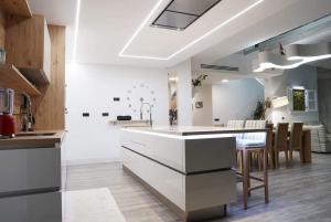 a kitchen with white cabinets and a dining room at Heaven Ocin in Telde