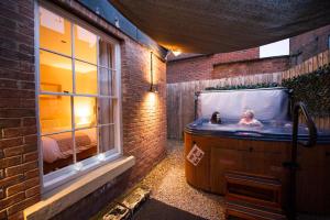 a bathroom with a tub with two people in it at Chester Apartments in Chester