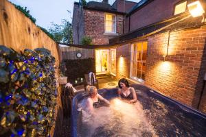 two people in a hot tub in a backyard at Chester Apartments in Chester