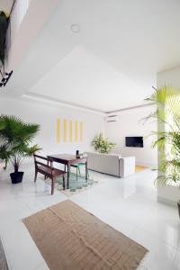 a living room with a table and a couch at NEW Canggu Modern 3BR Villa with big Pool & Garden in Umalas