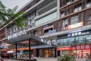 a building with signs on the side of it at Jiting International Hotel Jiaotong University Light Rail Station in Chongqing