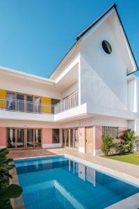 an exterior view of a house with a swimming pool at NEW Canggu Modern 3BR Villa with big Pool & Garden in Umalas