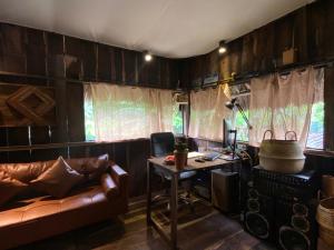 a living room with a couch and a desk at Cactos Chill & Homestay in Ho Chi Minh City