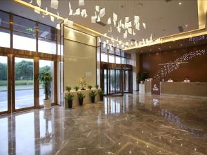 una hall di un edificio con piante in vaso di Lavande Hotel Wuxi East Railway Station a Wuxi