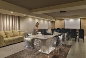 a living room with a couch and a table and chairs at Royal Garden Villas, Luxury Hotel in Adeje