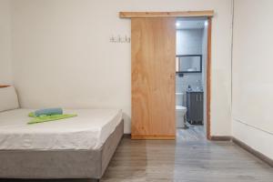a small bedroom with a bed and a bathroom at Hostal Machu Picchu Medellin in Medellín +12 photos