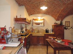 a large kitchen with a counter and a counter top at B&B Chez Annie in Donnaz